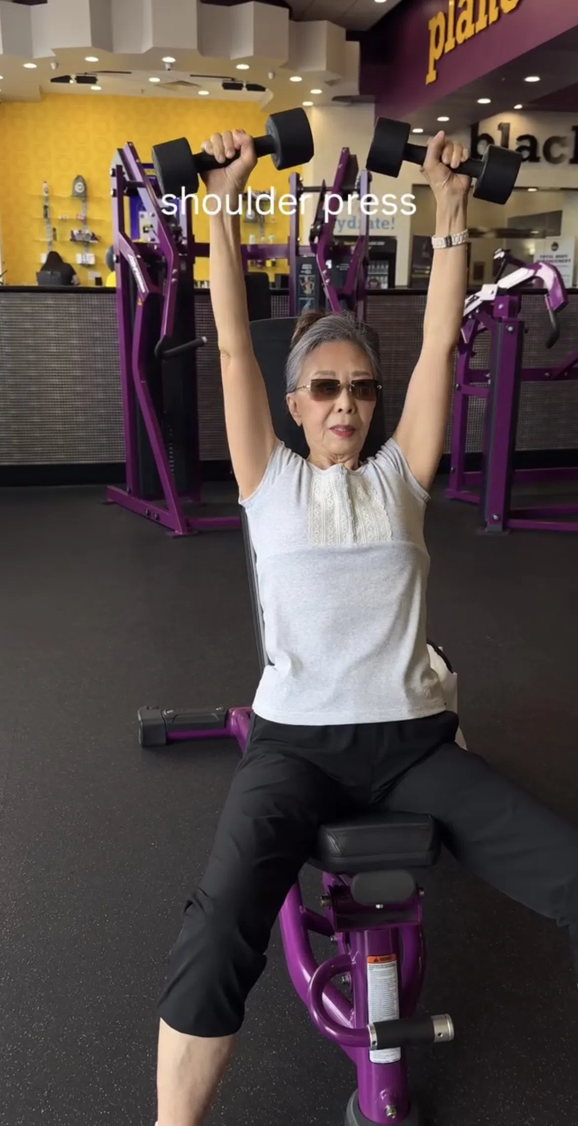 Oudere dame doet seated shoulder press